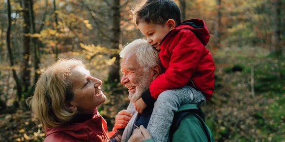 Grandparents with grandchild on grandfather's shoulders