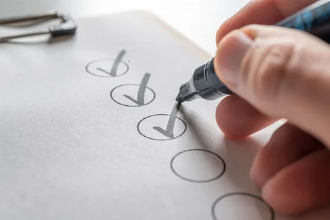 Financial advisor checking off financial goals listed on a financial action plan.