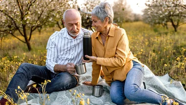 Older couple having a picnic outside